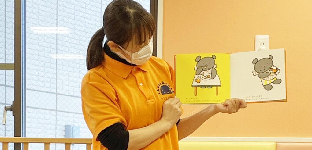 絵本を読む保育士